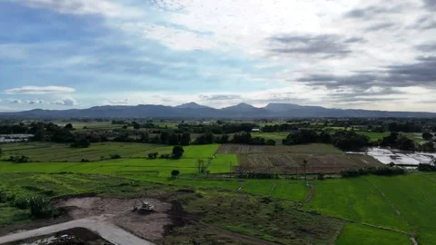 Drone flying right over grassy fields in Naic Cavite Philippines on cloudy sky Stock Footage 319844955