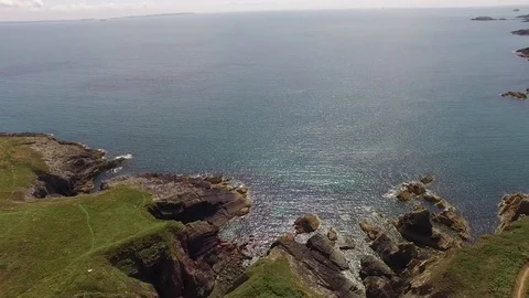 Drone flying into the sea over cliffs Stock Footage 77759833