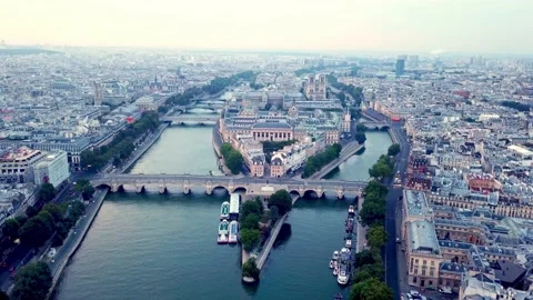 Drone flying Seine river towards Ile de la Cite with Pont Neuf bridge in Stock Footage 176448282