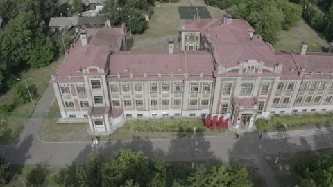 Drone flying sideways above historic industrial school building Stock Footage 333960648