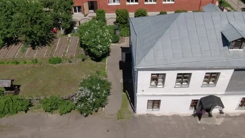 Drone flying sideways over house and garden plots Stock Footage 333414814