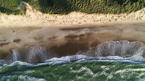 Drone flying sideways over long desolate beach at sunset in the spring Stock Footage 305564202