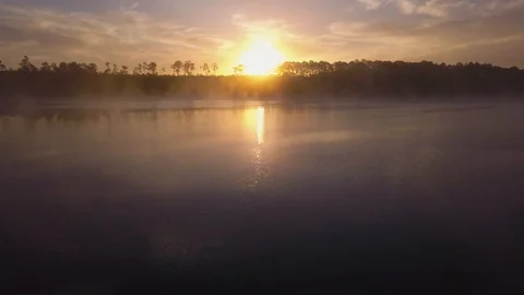 Drone Flying Sideways Over a Misty Lake at Sunrise in Ocala in 4K Stock Footage 93852891