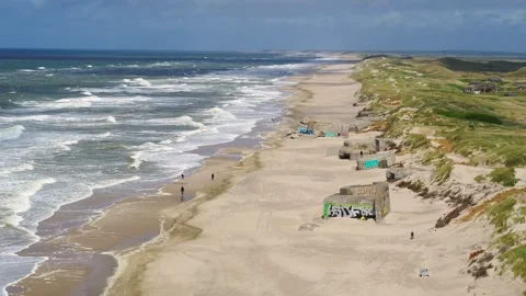 Drone flying sideways over old World War 2 bunkers at the Danish West coast Stock Footage 335993792