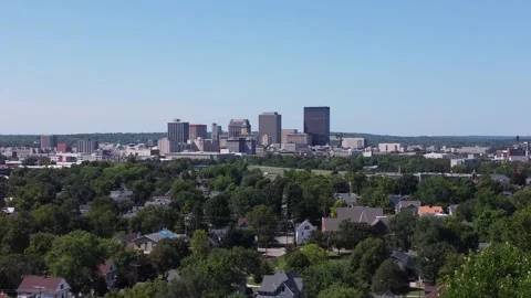 Drone flying sideways over trees towards city Stock Footage 160269638