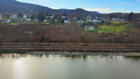 Drone flying sideways past a small, picturesque village in New York on the Stock Footage 144767648