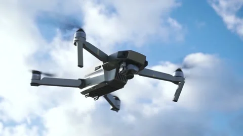 Drone flying in silhouette at blue sky background. Footage. Quadrocopter on city Stock Footage
