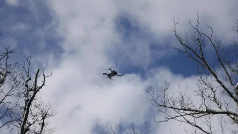Drone flying in the sky during winter with bare trees Stock Footage 300899299