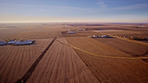 Drone flying slow perimeter around industrial wind farm build Video stock 329222807