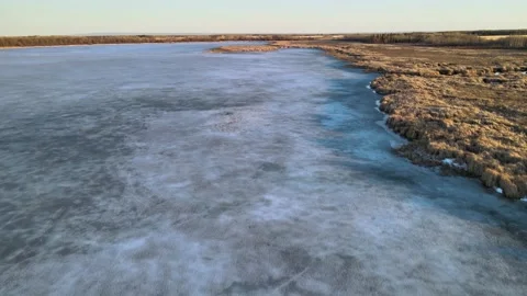 Drone flying slowly forward over a frozen lake Stock Footage 152171373