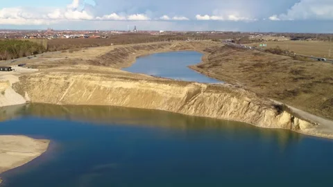 Drone flying slowly forwards over a beautiful lake next to a highway in Ros.. Stock Footage 283072594