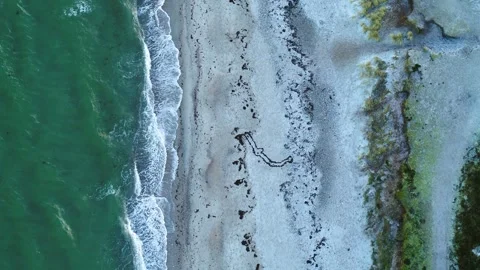 Drone flying slowly forwards over desolate beach on a winter morning Video stock 287915521