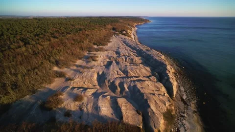 Drone flying slowly forwards over rocky shores of the Danish island Bornholm Stock Footage 314213419