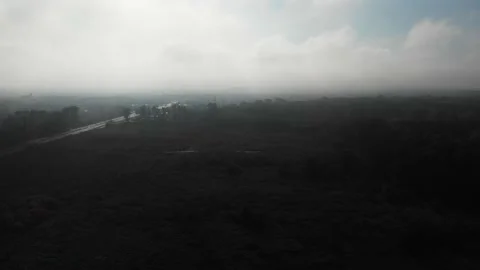 Drone flying slowly over dark misty fields with highway in Warsaw, Poland #2 Vídeos de archivo 141885258