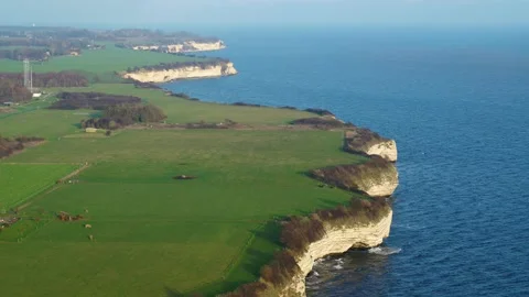 Drone flying slowly over fields and Stevns Klint Unesco World Heritage Video stock 272293929