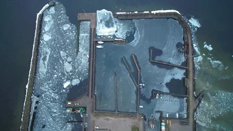 Drone flying slowly over ice packed boat marina in Denmark Stock Footage 287915535