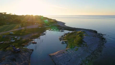Drone flying slowly over tiny marina towards the sunset Stock Footage 298651147