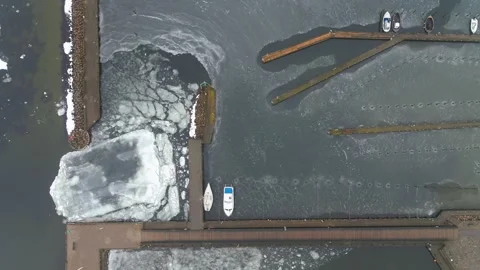 Drone flying slowly sideways over ice packed boat marina in Denmark Stock Footage 287915600