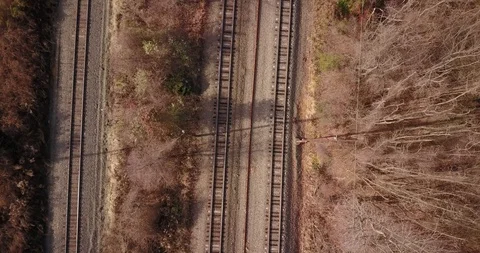 Drone flying straight down over train tracks fall Stock Footage 120303282