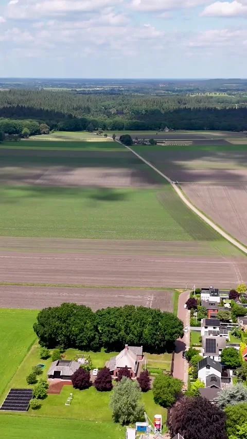 Drone flying straight forward revealing cultivated fields Stock Footage 338033196