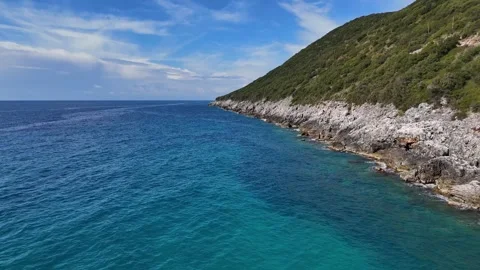 Drone Flying Straight Over Blue Sea Along Rocky Coastline Stock Footage 330883384