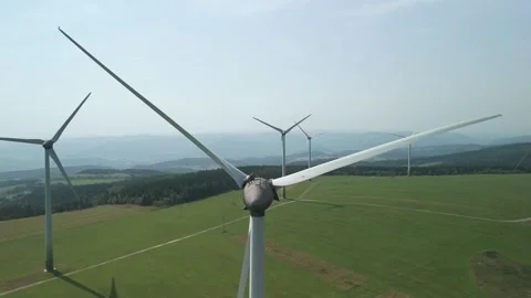 Drone Flying Straight Through Wind Turbine Blades from Unique Angle Stock Footage 314940409