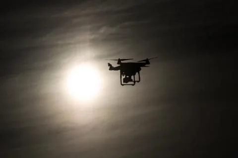 Drone flying into the sun Foto stock