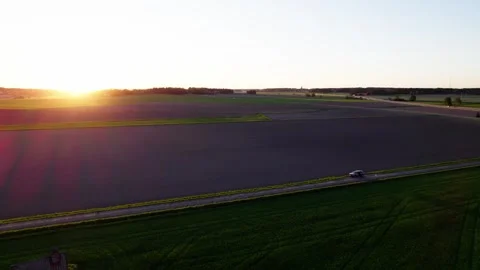 Drone flying in the sunset over the field Stock Footage 276530049
