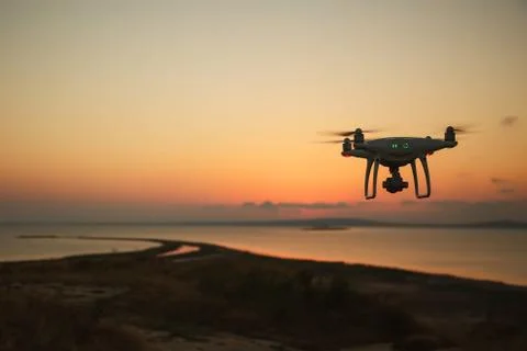 Drone flying at sunset over the sea. Camera drone on the russian south. Sunset Stock Photos