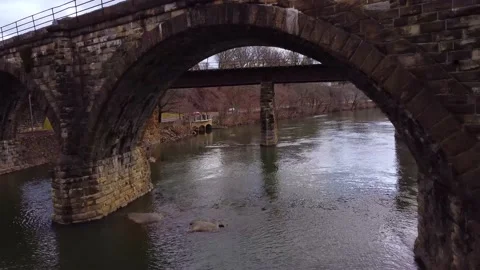 Drone Flying Through Archway Under Bridge Over River Headed South Philadelphia Video stock 146707177