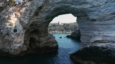 Drone flying through cave at coast with blue crystal clear water and rocks 2 Stock-Footage 145657761
