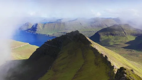 Drone flying through clouds. Aerial view of green grass mountain chain, in Видео 155478308
