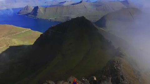 Drone flying through clouds. Aerial view of green grass mountain chain, in 動画素材 167350153