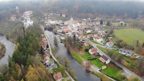Drone flying through the clouds over the autumn forest and river Stock Footage 257875657