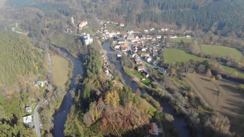 Drone flying through the clouds over the autumn forest and river Stock Footage 257875744
