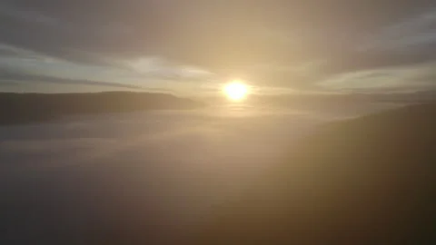 Drone flying through clouds over forest at sunrise, cinematic alpine landscape Stock Footage 325024627