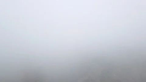 Drone is flying through the clouds towards high mountain peaks. Peaceful Stock Footage 94121594