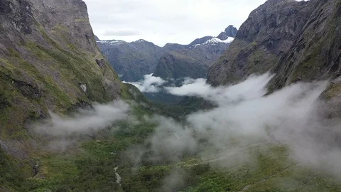 Drone flying through clouds in the valley of Mount Talbot, New Zealand Video stock 106453442