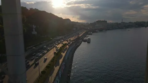 Drone is flying through a foot bridge over the river, view of a busy road, 4k Video stock 163894731