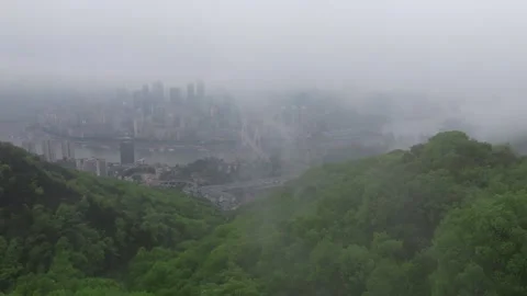 Drone Flying Through Low Clouds Toward Chongqing Skyline and Yangtze River Stock Footage 339746557