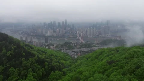 Drone Flying Through Low Clouds Toward Chongqing Skyline and Yangtze River Stock Footage 339747018