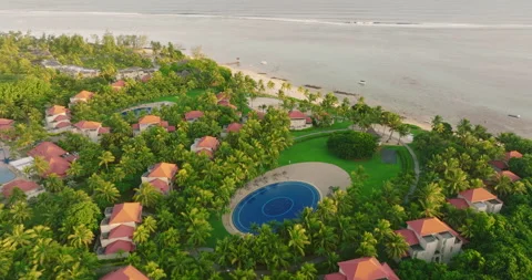 Drone flying through Miami beach beautiful three swimming pools filled with palm Stock Footage 200022672