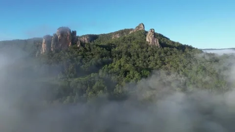 Drone flying through mist toward Nimbin Rocks Video stock 263428215