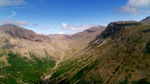 Drone flying through a mountain valley landscape 스톡 동영상 336806646