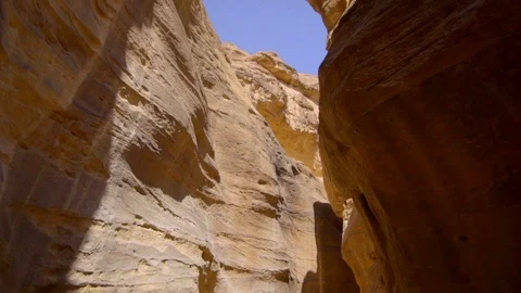 Drone flying through a narrow passage of canyon rocks in Petra Stock Footage 103522110