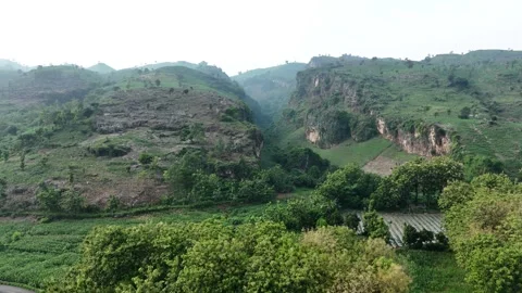 Drone Flying Through A Rock Mountain And Serene Valley Stock Footage 293540268