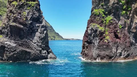 Drone flying through rocky gap in Miradouro Ilheus da Ribeira da Janela, Madeira Stock Footage 310369065