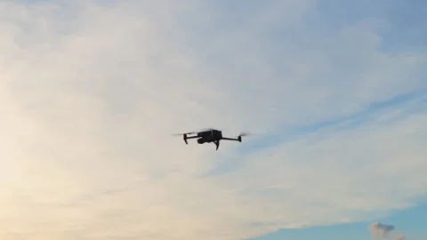 Drone flying through the sky during sunset with colorful clouds in the 스톡 동영상 339846423