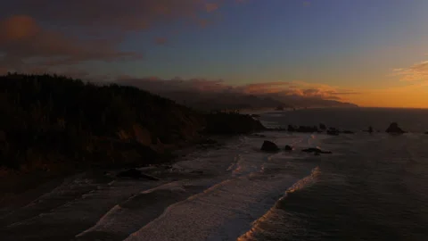 Drone flying through the sunset of Canon Beach, Oregon Stock Footage 145819855