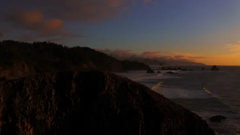 Drone flying through the sunset of Canon Beach, Oregon Stock Footage 145819895
